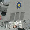 Officers and sailors man the rail as the crest of the Stervian Confederation is shown.