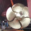 The size of the propellers dwarves the crew of the construction facility at Breukeln shipyard